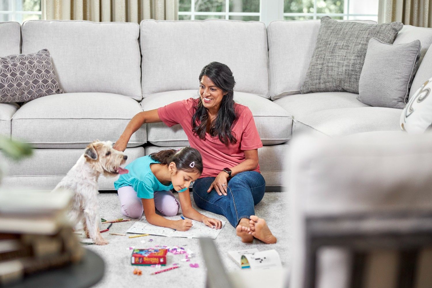 Mother and child spending time with their dog on a clean carpet after professional pet urine odour and stain removal by Eco Valley Chem-Dry in Calgary.