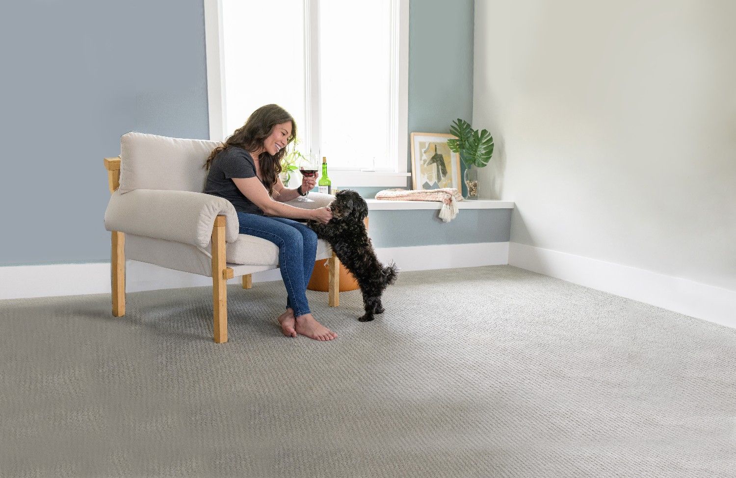 Woman bonding with her dog on freshly cleaned carpet after professional pet urine odour and stain removal by Eco Valley Chem-Dry in Calgary.