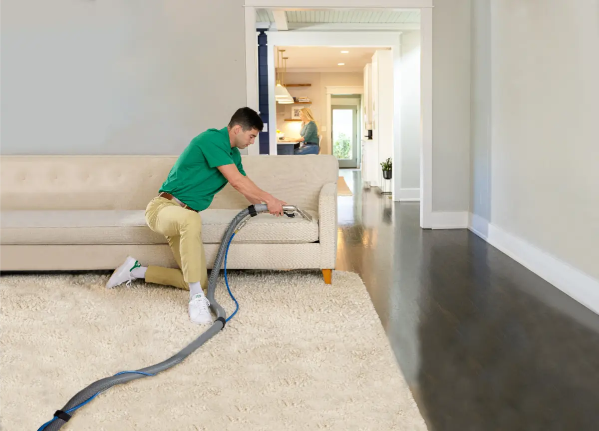 Okotoks carpet cleaning technician performing professional upholstery and carpet cleaning services inside a residential home