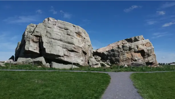 The Big Rock Erratic in Okotoks, a well-known natural landmark surrounded by green space and walking paths