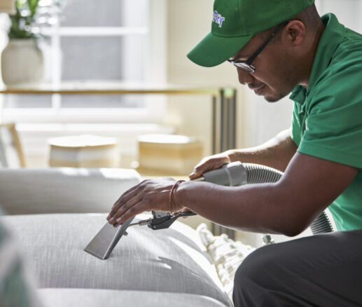 professional upholstery cleaning Eco Valley Chem-Dry technician performing professional upholstery cleaning on fabric sofa in Calgary home.