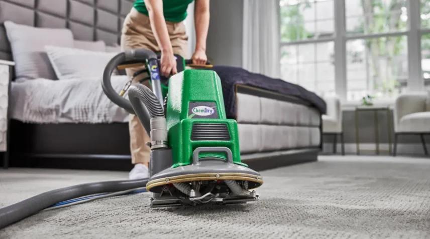 Professional carpet cleaning machine removing moisture from carpet to prevent mold growth and ensure faster drying after deep carpet cleaning.