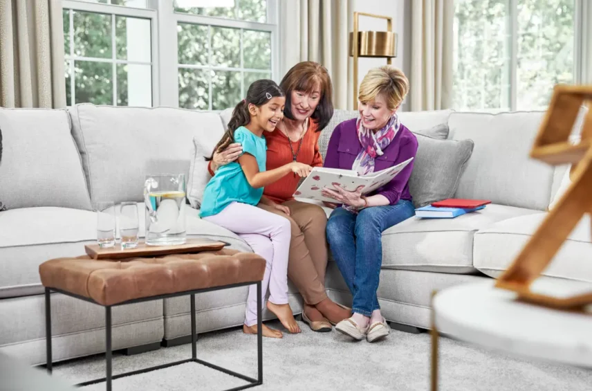 Family relaxing on a freshly cleaned couch in a Calgary living room after professional upholstery cleaning service