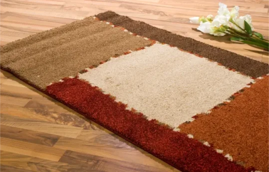 AreaRugonWoodcleaningservices Professionally cleaned area rug on a hardwood floor in a Calgary home