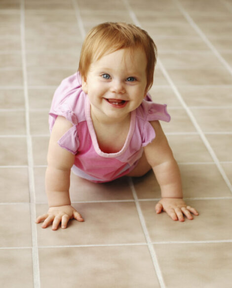 Baby crawling on professionally cleaned tile and grout floor
