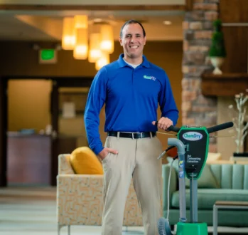 Chem-Dry technician with professional equipment showing why carpet cleaning is important for clean commercial spaces.