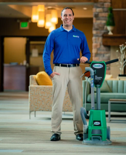 Chem-Dry technician with professional equipment explaining when cleaning carpet how long to dry.