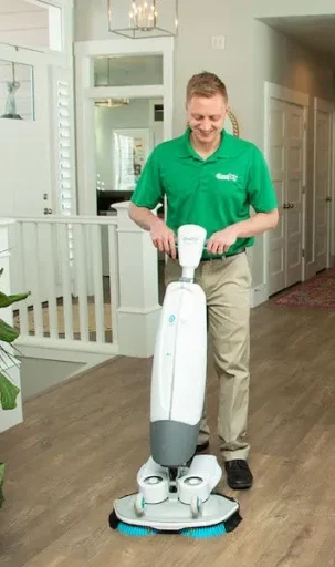 Eco Valley Chem-Dry technician professionally cleaning hardwood floors in a Calgary home