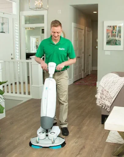 Eco Valley Chem-Dry technician professionally cleaning hardwood floors in a Calgary home