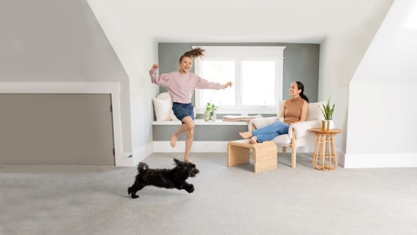 Family enjoying a clean, odor-free carpet after using the best urine smell remover for carpet to eliminate pet stains and dog pee smell