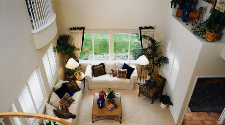 Spacious living room with a light-colored sofa, armchairs, and carpeted floor, representing a clean and well-maintained home interior suitable for professional carpet cleaning