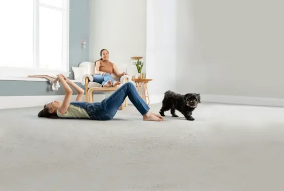 Mom daughter and dog 3 Child playing with a dog on a freshly cleaned carpet while a parent relaxes nearby.