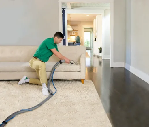 Cleaning services Cochrane technician performing professional sofa and upholstery cleaning in a residential home