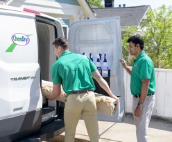 Cleaning services Cochrane technicians unloading equipment from a service van before starting professional carpet cleaning at a home