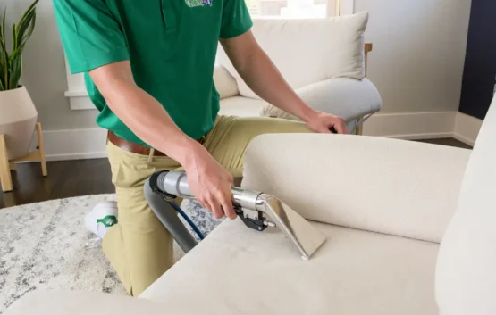 Professional upholstery cleaning in Kensington Calgary using extraction equipment on a fabric sofa