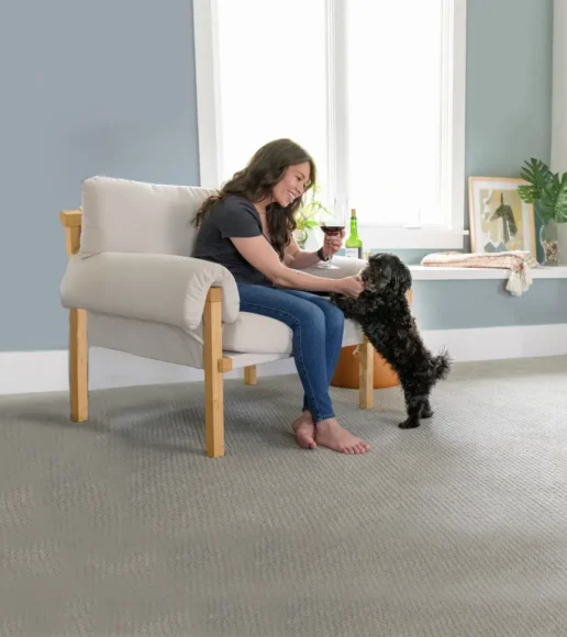 Woman with her dog on a fresh carpet after carpet cleaning helped get rid of dog urine.