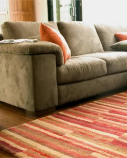 Fresh living room with clean sofa and area rug after professional cleaning services Cochrane for upholstery and carpets