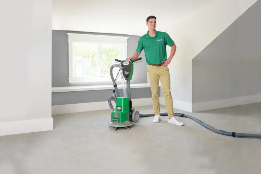 Professional carpet cleaning technician using low-moisture equipment for deep, fast carpet cleaning inside a residential home