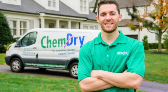Professional carpet cleaning technician standing in front of service van in Kensington Calgary