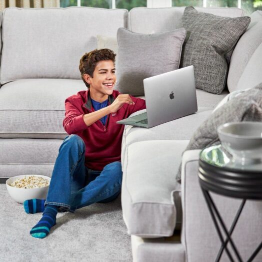 u3 Boy relaxing on freshly cleaned sofa after professional upholstery cleaning service by Eco Valley Chem-Dry in Calgary.